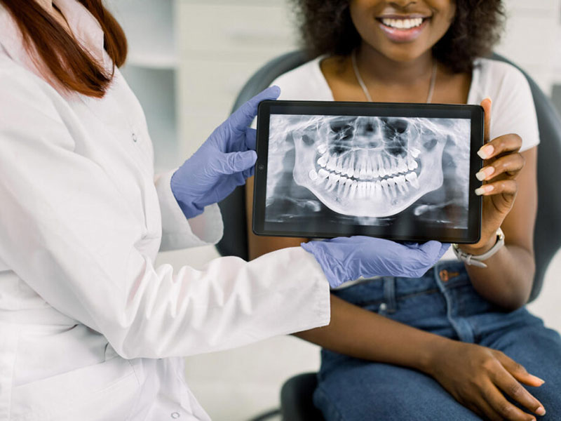 a patient and doctor holding dental x-ray